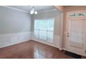 Bright dining area boasts hardwood floors, wainscoting and a large window at 210 Morning Dove Ln, Suwanee, GA 30024