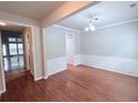 Bright dining room features hardwood floors, a modern light fixture and wainscoting at 210 Morning Dove Ln, Suwanee, GA 30024