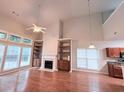 Spacious living room has hardwood floors, fireplace, built-ins, and large windows for natural light at 210 Morning Dove Ln, Suwanee, GA 30024