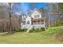 Charming two-story home featuring a quaint front porch and nicely landscaped yard at 76 Riverbend Trl, Douglasville, GA 30134