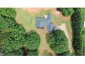 Aerial view showcasing property with a large lawn and lots of trees at 940 Sandy Ford Rd, Social Circle, GA 30025