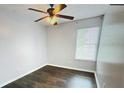 Cozy bedroom with ceiling fan, hardwood floors, and a bright window offering natural light at 4397 Stone Gate Way, Atlanta, GA 30344