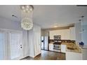 Modern kitchen features stainless steel appliances, granite countertops, stylish lighting, and ample storage space at 4397 Stone Gate Way, Atlanta, GA 30344