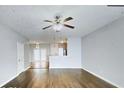 Spacious living room with hardwood floors, ceiling fan, and open layout to kitchen, great for entertaining at 4397 Stone Gate Way, Atlanta, GA 30344