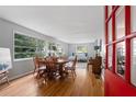 Bright dining room features hardwood floors and large windows with beautiful natural light at 433 Pine Dr, Pine Lake, GA 30072