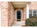 Close-up of the front door with brick facade and manicured shrubbery at 1076 Scenic Park Trl, Lawrenceville, GA 30046