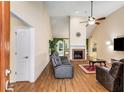 Inviting living room with vaulted ceilings, a cozy fireplace, and wood flooring at 115 Pinnacle Ln, Mcdonough, GA 30253
