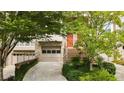 Townhome exterior with a driveway, a brick staircase, and a garage with a neutral-colored door at 1344 Fernwood Ne Cir, Brookhaven, GA 30319
