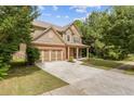 Attractive two-story home features a spacious driveway, lush greenery, and a welcoming facade at 224 Farm Manor Ct, Lawrenceville, GA 30045