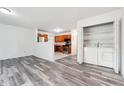 Open-concept living area with kitchen view, modern wood flooring, and convenient washer/dryer access at 3799 Henry Ct, Acworth, GA 30101
