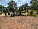 Backyard view with detached shed and pile of rubble at 3700 Moore Rd, Austell, GA 30106