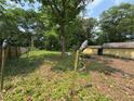 View of the backyard surrounded by wooden fence and trees at 3700 Moore Rd, Austell, GA 30106