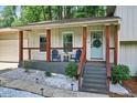 Inviting front porch with cozy seating and a decorative wreath adds charm to this home's curb appeal at 5341 Tall Oak Dr, Marietta, GA 30068