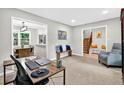 Bright living room showcasing neutral paint, carpeted floors, and comfortable seating area at 5341 Tall Oak Dr, Marietta, GA 30068