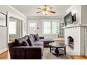 Cozy living room with hardwood floors, fireplace, and large comfortable couch at 608 Hardendorf Ne Ave, Atlanta, GA 30307