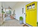 Inviting front porch with rocking chairs and a porch swing, complemented by a bright yellow door at 907 Eden Se Ave, Atlanta, GA 30316