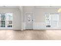 Bright living room with white trim and hardwood floors, illuminated by natural light at 2030 Brook Meadow Dr, Alpharetta, GA 30005