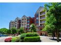 Beautiful exterior of condo building featuring private balconies, manicured landscaping and mature trees at 211 Colonial Homes Nw Dr # 2304, Atlanta, GA 30309