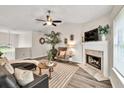 Bright living room features vaulted ceiling, fireplace, stylish decor, and modern ceiling fan at 240 Mountain Ln, Covington, GA 30016