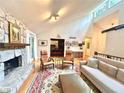 Bright living room boasts a stone fireplace, hardwood floors, and vaulted ceilings for an airy feel at 2960 Cedar Knoll Dr, Roswell, GA 30076