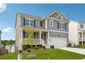 Attractive two-story home with gray siding, black shutters, a covered porch and a well-maintained lawn at 96 Quail Bend Way, Dallas, GA 30157