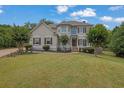 Charming two-story home with a well-manicured lawn, beautiful landscaping, and inviting curb appeal at 1745 Stoney Brook Way, Alpharetta, GA 30005
