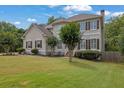 Beautiful two-story home with a manicured lawn, trimmed trees, and classic shutters at 1745 Stoney Brook Way, Alpharetta, GA 30005