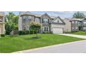 Charming two-story home featuring a lush lawn and well-maintained landscaping at 4650 Orchard View Way, Cumming, GA 30028