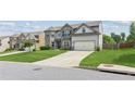 Desirable neighborhood featuring a two-story home, with green lawn, and two-car garage at 4650 Orchard View Way, Cumming, GA 30028