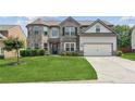 Beautiful two-story home with well-manicured lawn, gray brick, and two-car garage at 4650 Orchard View Way, Cumming, GA 30028