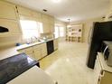 The kitchen features ample cabinet space, laminate floors, a stainless steel fridge, and a dining area at 542 Banks E Rd, Fayetteville, GA 30214
