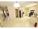 Spacious eat-in kitchen features lots of cabinets, stainless steel refrigerator, and laminate flooring at 542 Banks E Rd, Fayetteville, GA 30214