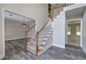 Spacious foyer boasts hardwood floors and staircase with white railings and carpeted steps at 863 Fairlong Nw Way, Acworth, GA 30101