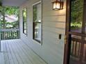 Inviting front porch with gray wood planks and a charming lantern-style light fixture at 219 Park Avenue, Woodstock, GA 30188