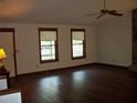 Open-concept living room with gleaming hardwood floors, and natural lighting at 219 Park Avenue, Woodstock, GA 30188