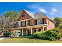 Side view of a brick home with black shutters and a manicured lawn at 4729 Woodland Brook Se Ct, Atlanta, GA 30339