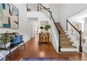 Bright foyer with hardwood floors, staircase, and elegant decor at 4729 Woodland Brook Se Ct, Atlanta, GA 30339