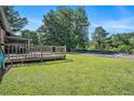 A large backyard with a wooden deck and an in-ground pool covered for the season at 3080 Keenan Rd, Atlanta, GA 30349