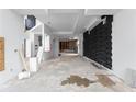 Unfinished interior space showcasing modern design with concrete floors and a unique black accent wall at 5210 Brownlee Rd, Stone Mountain, GA 30087