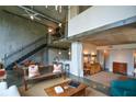 Open living space with modern staircase, concrete accents, and view of the kitchen bar area at 850 Ralph Mcgill Ne Blvd # 6, Atlanta, GA 30306