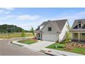 New construction home with a side entry two car garage, a sidewalk, and manicured landscaping at 1659 Tielman Way, Snellville, GA 30078