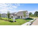 An exterior side view shows the home's architectural style, landscaping, and white color palette at 1659 Tielman Way, Snellville, GA 30078