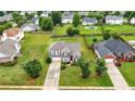 Charming brick-and-siding home featuring a well-manicured lawn and beautiful landscaping at 2127 Grant Ave, Mcdonough, GA 30252