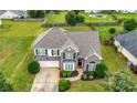 Charming brick-and-siding home featuring a well-manicured lawn and beautiful landscaping at 2127 Grant Ave, Mcdonough, GA 30252