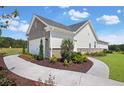 Side view of a charming home with gray brick, white siding and a concrete walkway at 248 Nesta Grove, Locust Grove, GA 30248