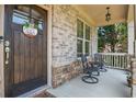 Inviting front porch with seating, decorative accents and charming curb appeal at 355 Glynnwilde Nw Dr, Marietta, GA 30064