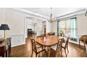 Formal dining room with hardwood floors, wainscoting, and a traditional chandelier at 622 Rocky Creek Pt, Woodstock, GA 30188