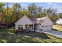 Charming home with white siding, stone accents, and a welcoming front porch with chairs at 728 Harmony Rd, Temple, GA 30179