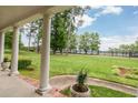 Scenic view from the home's porch overlooking the lush green lawn and surrounding trees at 2808 Peeler Rd, Dunwoody, GA 30360
