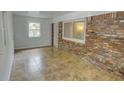 Cozy sunroom featuring brick walls and tiled floor offering natural light at 2808 Peeler Rd, Dunwoody, GA 30360